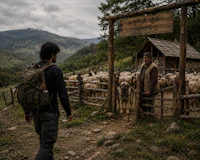 a man with a backpack standing next to a fence with sheep